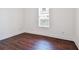 Bright bedroom with dark hardwood floors and a window with blinds at 1565 13Th S St, St Petersburg, FL 33705