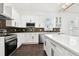 Spacious kitchen with white cabinets, quartz countertops, and stylish backsplash at 1565 13Th S St, St Petersburg, FL 33705