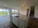 Open-concept kitchen with granite counters, stainless dishwasher, and seamless access to a spacious living area at 16017 7Th E Ave, Bradenton, FL 34212