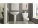 Stylish powder room with pedestal sink and toilet at 18194 Serene Lake Loop, Lutz, FL 33548