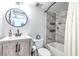 Updated bathroom with marble tile, vanity, and bathtub shower at 2060 Marilyn St # 241, Clearwater, FL 33765