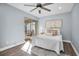 Spacious bedroom with a queen-size bed, ceiling fan, and access to balcony at 2060 Marilyn St # 241, Clearwater, FL 33765