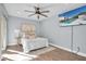 Bright bedroom with a queen-size bed, ceiling fan, and large TV at 2060 Marilyn St # 241, Clearwater, FL 33765