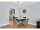 Chic dining room with a glass top table, grey chairs, and modern light fixture at 2060 Marilyn St # 241, Clearwater, FL 33765