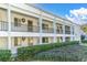 Multi-Gathering exterior featuring white walls, black railings, and well-maintained landscaping at 2060 Marilyn St # 241, Clearwater, FL 33765