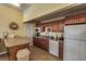 Community kitchen with wood cabinets, appliances, and an island at 2060 Marilyn St # 241, Clearwater, FL 33765