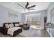 Spacious living room with L-shaped sectional sofa, wood floors, and access to a balcony at 2060 Marilyn St # 241, Clearwater, FL 33765