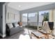 Comfortable living room with a plush sofa, modern chair, and sliding glass door to a balcony at 2060 Marilyn St # 241, Clearwater, FL 33765