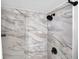 Modern shower with marble tile and black fixtures at 2060 Marilyn St # 241, Clearwater, FL 33765