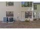 Back exterior view of condo, showing AC units and private entrance at 3034 Eastland Blvd # D108, Clearwater, FL 33761