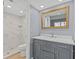 Clean bathroom with gray vanity, marble countertop and a shower/tub combo at 3034 Eastland Blvd # D108, Clearwater, FL 33761
