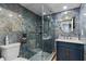Modern bathroom with blue marble tile and a walk-in shower at 3034 Eastland Blvd # D108, Clearwater, FL 33761