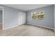 Bright bedroom with light gray walls and wood-look flooring at 3034 Eastland Blvd # D108, Clearwater, FL 33761