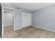 Spacious bedroom with wood-look floors and mirrored closet doors at 3034 Eastland Blvd # D108, Clearwater, FL 33761