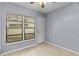 Cozy bedroom with tile floors, dual windows, and a door at 3034 Eastland Blvd # D108, Clearwater, FL 33761