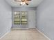Cozy bedroom with tile floors, dual windows, and a door at 3034 Eastland Blvd # D108, Clearwater, FL 33761