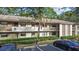 Front view of condo building showcasing landscaping and parking at 3034 Eastland Blvd # D108, Clearwater, FL 33761