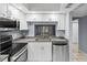 Modern kitchen with stainless steel appliances and granite countertops at 3034 Eastland Blvd # D108, Clearwater, FL 33761