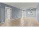 Living room with tile flooring and ceiling fan, view of bathroom at 3034 Eastland Blvd # D108, Clearwater, FL 33761