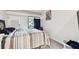 Bedroom with striped bedding and access to patio at 36750 Us Highway 19 N # 01104, Palm Harbor, FL 34684