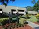 Exterior view of Berkshire Lodge 2, showing building, landscaping, and walkway at 36750 Us Highway 19 N # 01104, Palm Harbor, FL 34684