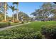 Landscaped grounds with lush greenery, palm trees, and a walkway at 36750 Us Highway 19 N # 01104, Palm Harbor, FL 34684