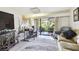 Living room with access to patio and workspace at 36750 Us Highway 19 N # 01104, Palm Harbor, FL 34684