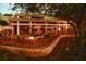 Evening view of outdoor patio with fire pit and seating at 36750 Us Highway 19 N # 01104, Palm Harbor, FL 34684