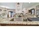 Close-up of kitchen sink with granite countertop, faucet, and cleaning supplies at 36750 Us Highway 19 N # 09122, Palm Harbor, FL 34684