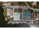 High-angle view of community pool, tennis courts, and marina at 3954 Marine Pkwy, New Port Richey, FL 34652