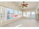 Bright sunroom with water views and ceiling fan at 3954 Marine Pkwy, New Port Richey, FL 34652