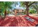 One-story home with red mulch landscaping and stone pathway at 5105 Epping Ln, Zephyrhills, FL 33541