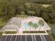 Community pool with lounge chairs and building at 5105 Epping Ln, Zephyrhills, FL 33541