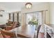 Dining area with wooden table and access to the living room at 5167 6Th N Way, St Petersburg, FL 33703