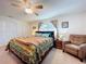 Bright bedroom with king bed, ceiling fan, and comfortable armchair at 5213 Lantana St, Zephyrhills, FL 33542