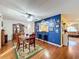 Dining area with hardwood floors, and view into kitchen at 5213 Lantana St, Zephyrhills, FL 33542