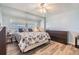 Bright bedroom with a floral-print bed and wood-look floors at 5312 Mary St, Zephyrhills, FL 33542