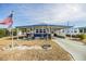 Florida mobile home with carport, landscaped yard, and American flag at 5312 Mary St, Zephyrhills, FL 33542