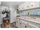 Kitchen with white cabinets, double sink, and a view at 5312 Mary St, Zephyrhills, FL 33542