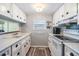 Bright white kitchen with ample cabinetry and modern appliances at 5312 Mary St, Zephyrhills, FL 33542