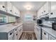 Bright white kitchen with ample cabinetry and modern appliances at 5312 Mary St, Zephyrhills, FL 33542