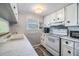 Bright white kitchen with ample cabinetry and modern appliances at 5312 Mary St, Zephyrhills, FL 33542