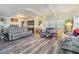 Open living space with gray reclining sofas and wood flooring at 5312 Mary St, Zephyrhills, FL 33542