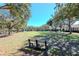 Peaceful community park with a bench, lush green grass, and mature trees at 5314 Golden Isles Dr, Apollo Beach, FL 33572