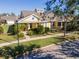 Exterior view of a yellow house with a porch and landscaping at 5314 Golden Isles Dr, Apollo Beach, FL 33572