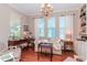 Home office with built-in shelving, hardwood floors, and a comfortable sitting area at 5314 Golden Isles Dr, Apollo Beach, FL 33572