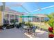 Relaxing screened patio with seating area, perfect for outdoor enjoyment at 5314 Golden Isles Dr, Apollo Beach, FL 33572