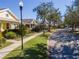 Community street view showing charming yellow houses and landscaping at 5314 Golden Isles Dr, Apollo Beach, FL 33572