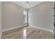 Bright, light-filled bedroom featuring a modern ceiling fan and beautiful wood-look tile flooring at 5713 Tybee Island Dr, Apollo Beach, FL 33572