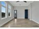 Spacious bedroom featuring wood-look flooring, large windows, and blue doors that add a touch of color at 5713 Tybee Island Dr, Apollo Beach, FL 33572